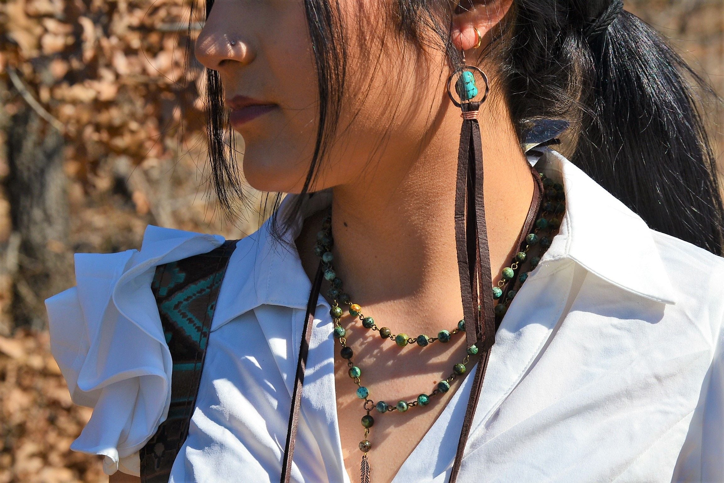 A Girl Wearing Turquoise Drop Earrings w/ Brown Leather Tassel