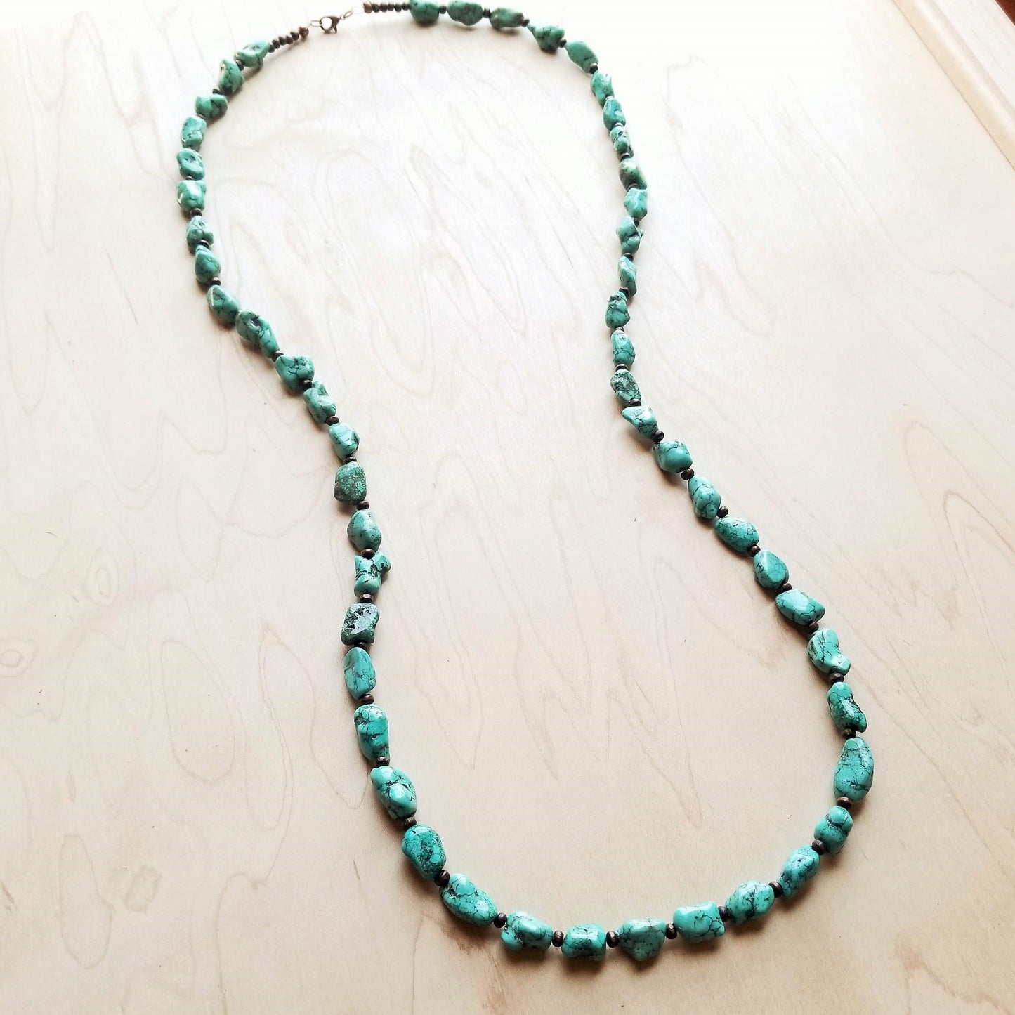 A long turquoise necklace with wooden beads from The Jewelry Junkie.